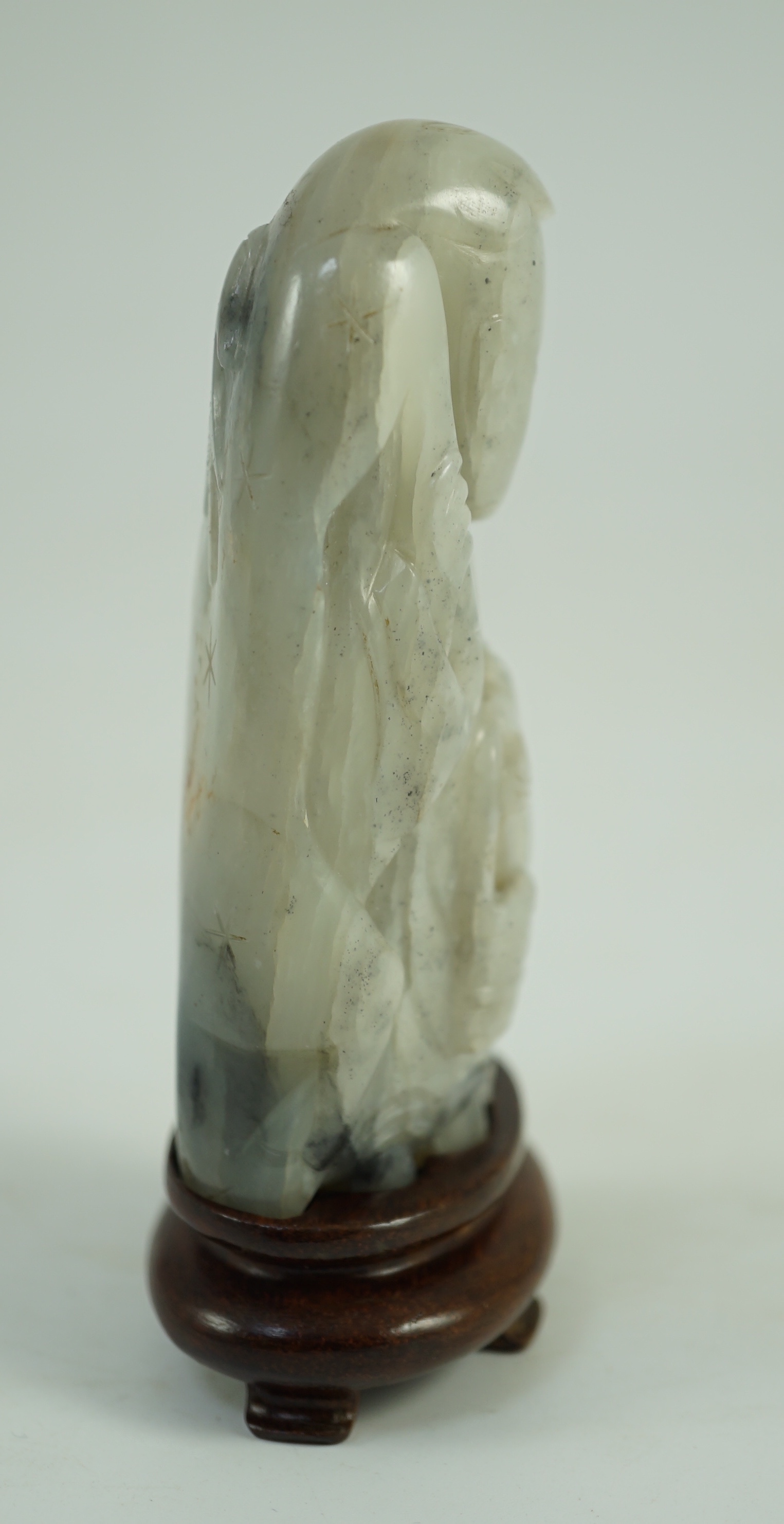 A Chinese white, grey and russet jade figure of Zhou Yanzi, Ming dynasty, 8.5cm high, Filled hole to figure, wood stand